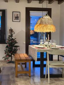 a dining room with a table and a christmas tree at Chalet con encanto Jardín y Parking Privado in Vielha