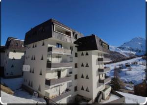 a tall apartment building with snow on the ground at Casa di Cricci in Sestriere