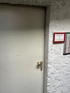 a white door with a sign on a wall at Casa di Cricci in Sestriere +57 photos