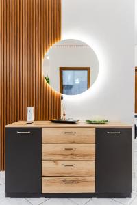 a bathroom with a wooden dresser and a mirror at Beachfront Apartments Durres in Durrës