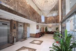 a lobby of a building with a chandelier at Nasamaat Ajyad Hotel in Mecca