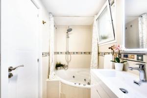 een badkamer met een bad en een wastafel bij Comfortable house in Fuengirola with terrace in Fuengirola +55 foto's