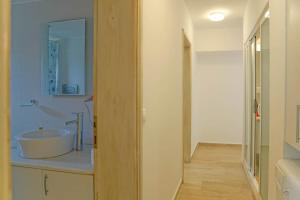 a bathroom with a tub and a sink with a mirror at Mona Apart with sea platform in Yarim Adası +49 photos