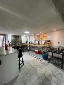 a large kitchen with a lot of counters and appliances at Casa Central in Porto Seguro