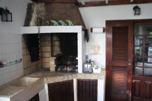 a kitchen with a sink and a stone counter top at João Jungle in Açafora