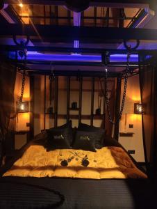 a bedroom with a bed with a blue light at Appartement LOVE ROOM LUXE in Bavay