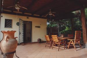 a patio with a table and chairs and a vase at Royal Palace B&B in Caserta