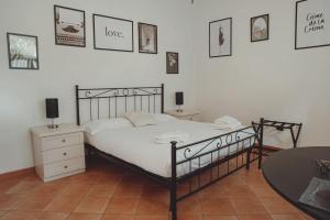 a bedroom with a bed and pictures on the wall at Royal Palace B&B in Caserta