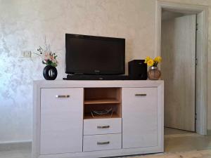 a tv on top of a white entertainment center at Jelena in Igalo