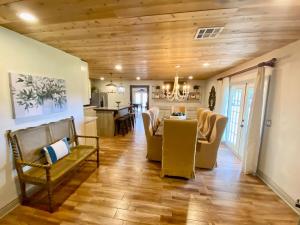 a dining room and living room with a table and chairs at The Manor House in Kingston +7 photos