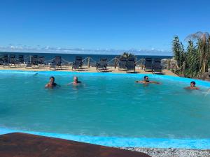 a group of people swimming in a swimming pool at Vida buena in Punta Del Diablo