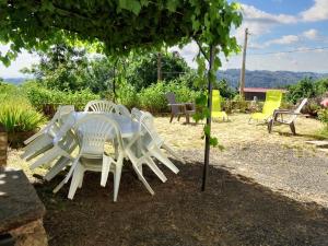 a white table and chairs under a tree at Maison charmante à Mercœur avec jardin et parking in Mercoeur
