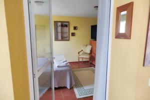 a glass door leading into a room with a chair at Cozy apartment in Collado Villalba 100 m² with open garden in Collado-Villalba +27 photos