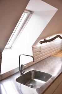 a kitchen with a sink and a skylight at Visby innerstad St Hans in Visby +11 photos