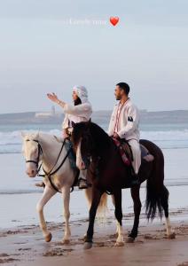 deux personnes à cheval sur la plage dans l'établissement RELAXING EXPERIENCE In ESSAOUIRA-VILLA OLIVE, à Essaouira 34 autres photos