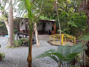 a playground in a garden with a yellow swing at Casa em Penha in Penha +8 photos