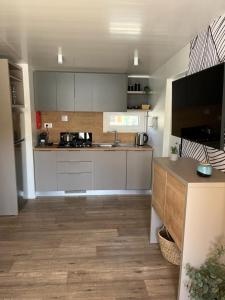 a kitchen with white cabinets and a counter top at Mobile Home B in Biograd na Moru
