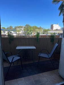 a table and two chairs on a balcony with a table at Casa Dos Avenidas 4 Dormitorios in Montevideo +36 photos