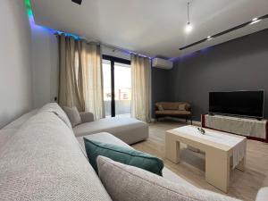 a living room with a couch and a tv at B2 Apartment 3 in Kashari