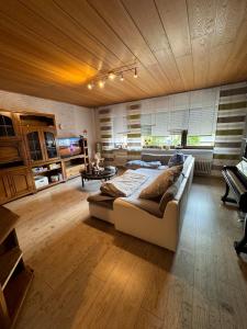 a large living room with a couch and a table at Ferienwohnung beim Pferdehof in Neuenstein +24 photos
