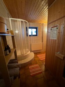 a large bathroom with a shower and a window at Ferienwohnung beim Pferdehof in Neuenstein