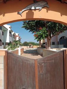 a wooden gate with a bird on top of it at Holiday Maio in Calheta Do Maio