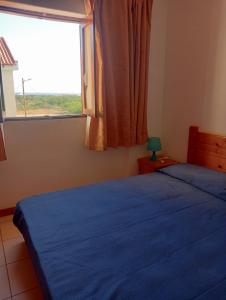 a bedroom with two beds and a window at Holiday Maio in Calheta Do Maio +16 photos