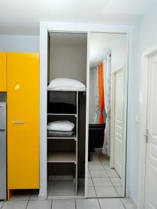 a room with a bunk bed and a yellow door at Appartement vue mer situé aux Trois-Ilets, Martinique in Les Trois-Îlets +7 photos