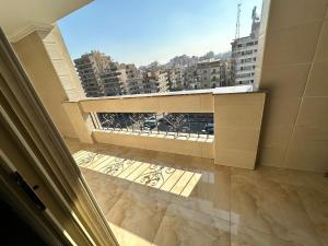 a balcony with a view of a city at King Palace Rooms in Cairo