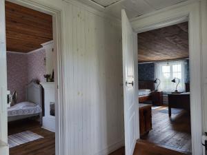 an open doorway to a room with a bedroom at Bullerbyn - Mellangården - Astrid Lindgren family house in Mariannelund