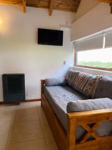 a living room with a couch and a flat screen tv at La Tante in San Carlos de Bariloche