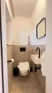 a bathroom with a toilet and a sink at Gästehaus im Grünen in Pesendorf +17 photos