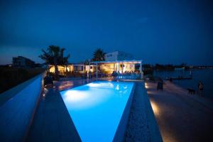 a swimming pool with blue lights on top of a building at Arcadia - Beach villa n.1 in Privlaka