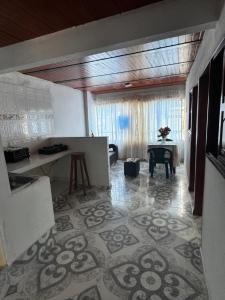 a living room with a table and a kitchen at Hostal San Felipe in El Peñón