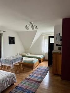 a living room with two beds and a table at Czarna Jagoda in Czarna Góra