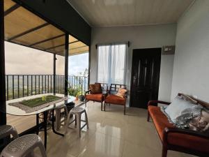 a living room with a balcony with a table and chairs at Bellavista Ceci A2 in San Ramón