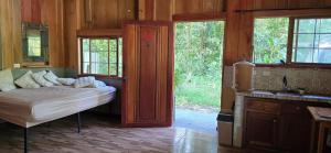 a bedroom with a bed and a sink and windows at Cabaña Rio Diamante in San Luis