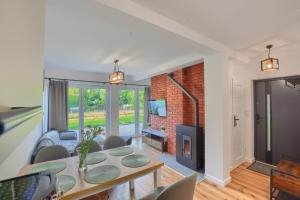 a living room with a table and a fireplace at Osada Pod Maliną in Brenna