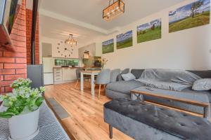 a living room with a couch and a table at Osada Pod Maliną in Brenna
