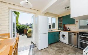 a kitchen with green cabinets and a white refrigerator at Ophelia in Dublin