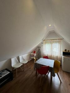 a room with a table and chairs in a attic at Czarna Jagoda in Czarna Góra