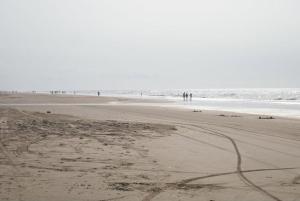 a group of people walking on the beach at Recanto do pepe in Chuí