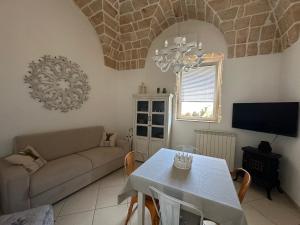 a living room with a couch and a table at La terrazza di Lillo in Carovigno