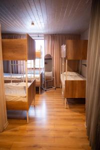 a room with two bunk beds and a window at Hostel Emes in Astana