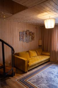 a living room with a couch in the corner at Hostel Emes in Astana +2 photos