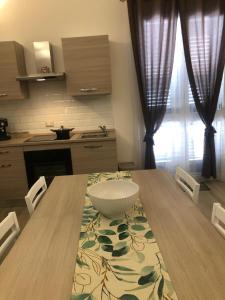 a kitchen with a wooden table with a bowl on it at Le Antiche Alcove in Terrasini