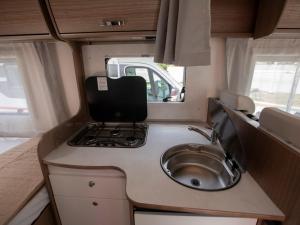 a small kitchen with a sink in an rv at CamperLifeCrete in Chania Town