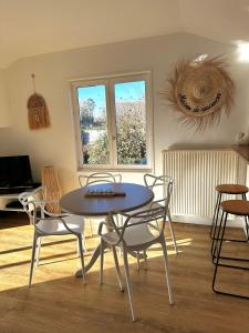 a dining room with a table and chairs in a room at Little Omaha in Vierville-sur-Mer +19 photos