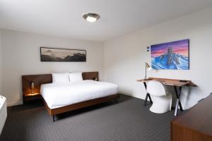 a hotel room with a bed and a desk at Adara Hotel in Whistler