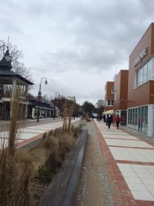 a street with buildings and people walking on the sidewalk at Albatros in Świnoujście +27 photos
